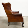 Distressed antique Georgian leather wingback armchair