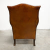 Distressed antique Georgian leather wingback armchair